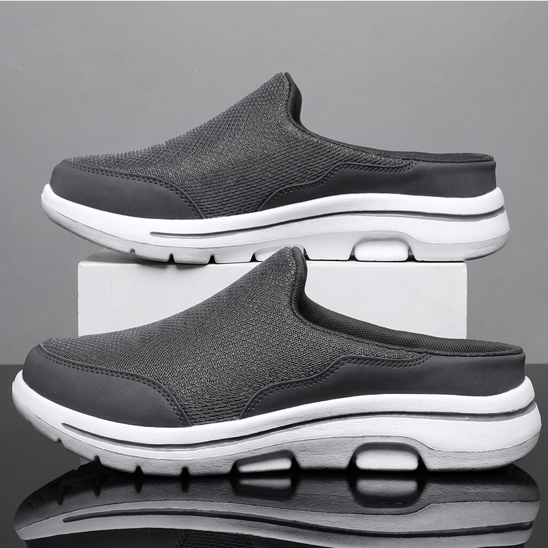 Gray backless mesh sneakers on a display block