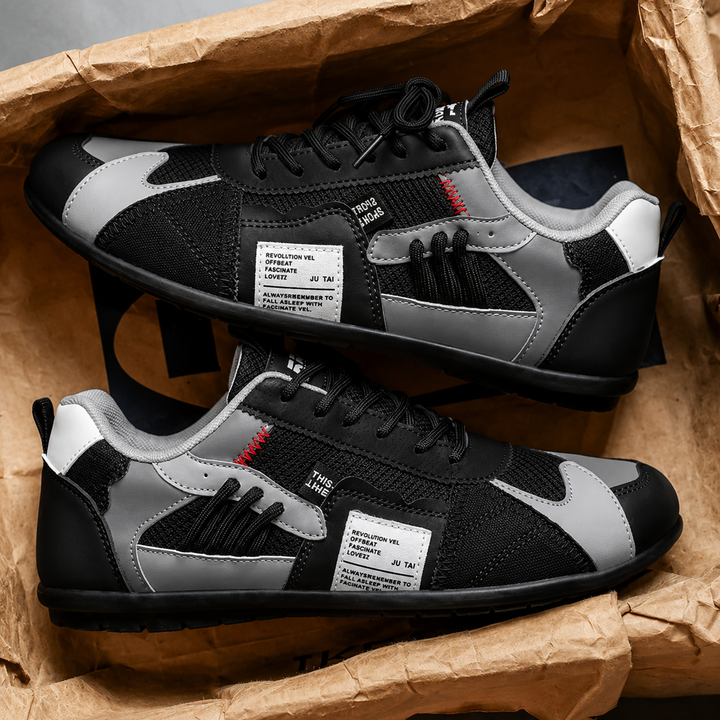 Black retro lace-up low tops with gray accents, pair in a box