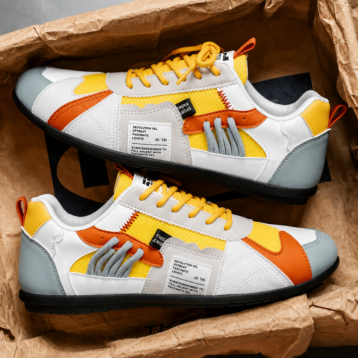 Yellow and white color block sneakers with orange trim, pair view