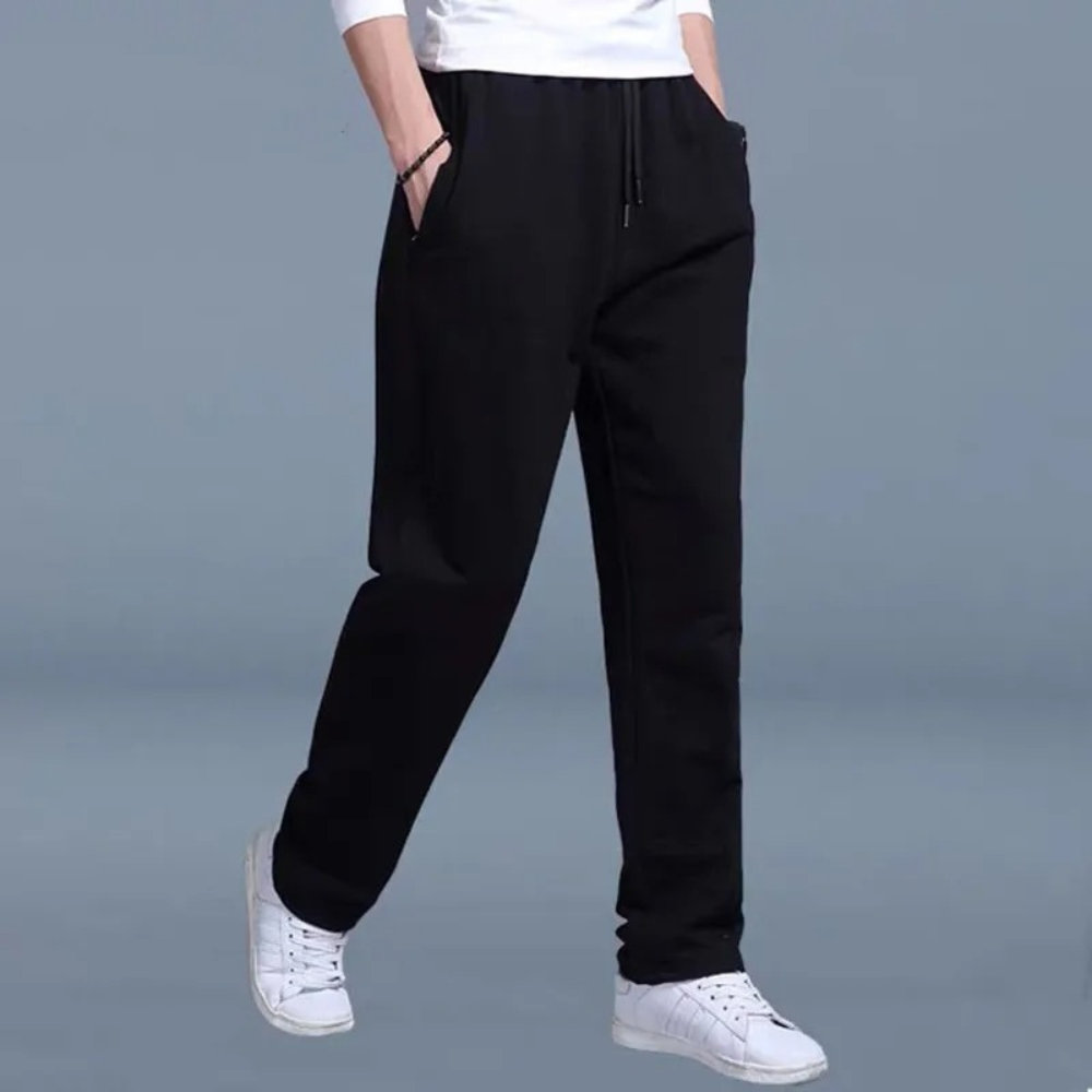 Men's black straight leg sweatpants, front view on a model