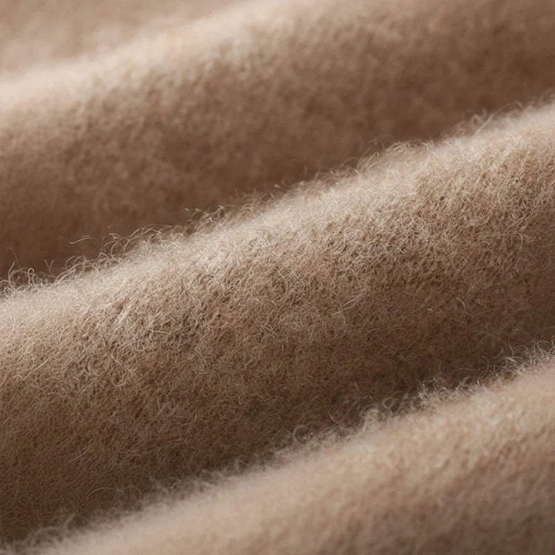 Macro view of the soft brushed knit texture in camel