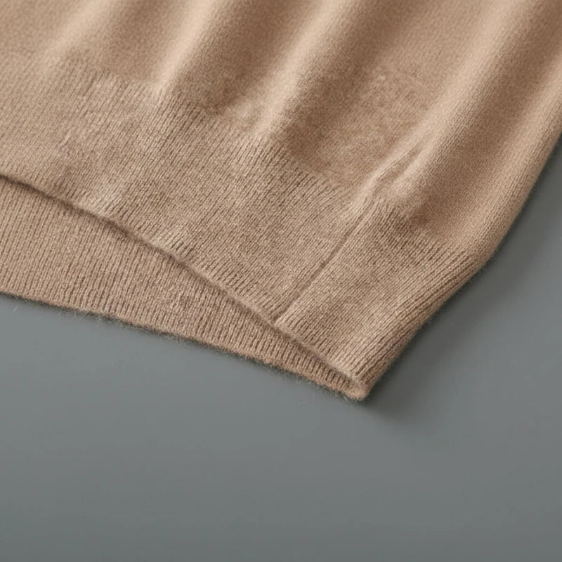 Close view of the ribbed hem on the camel knit vest