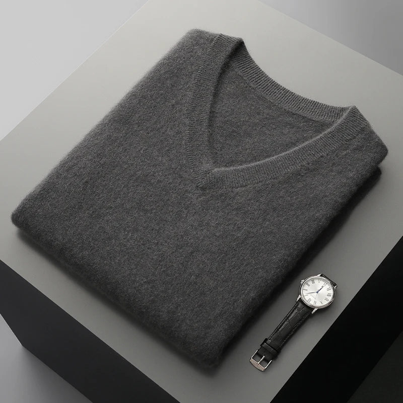 Dark gray V-neck knit vest folded on a gray display block
