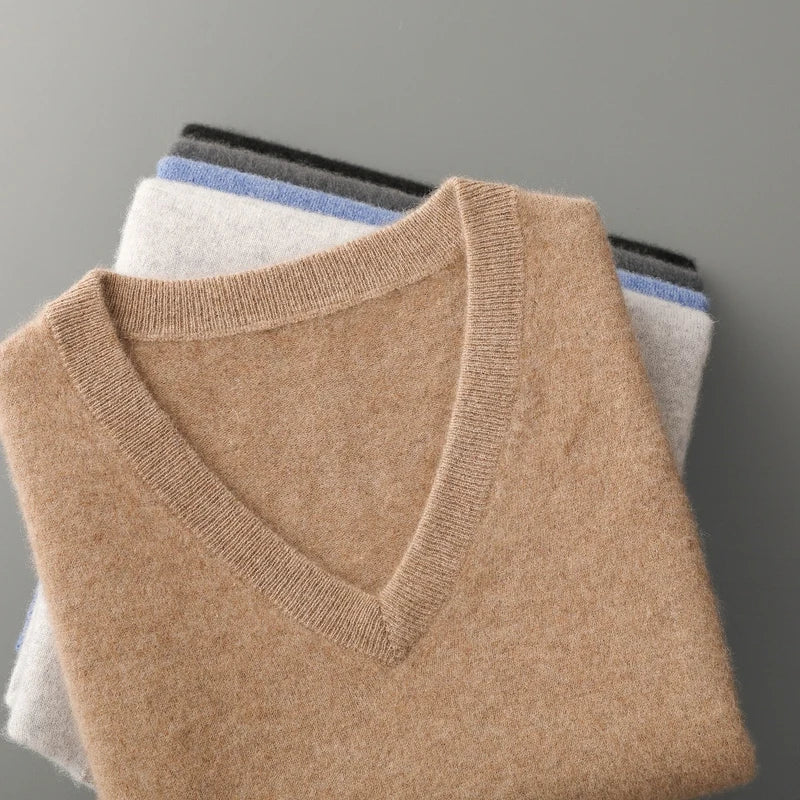 Stack of sweater vests in camel, light gray, blue and charcoal