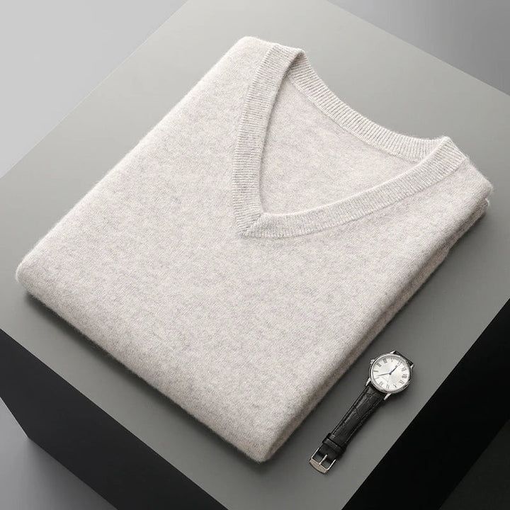 Light gray sweater vest folded flat with the V-neck on top