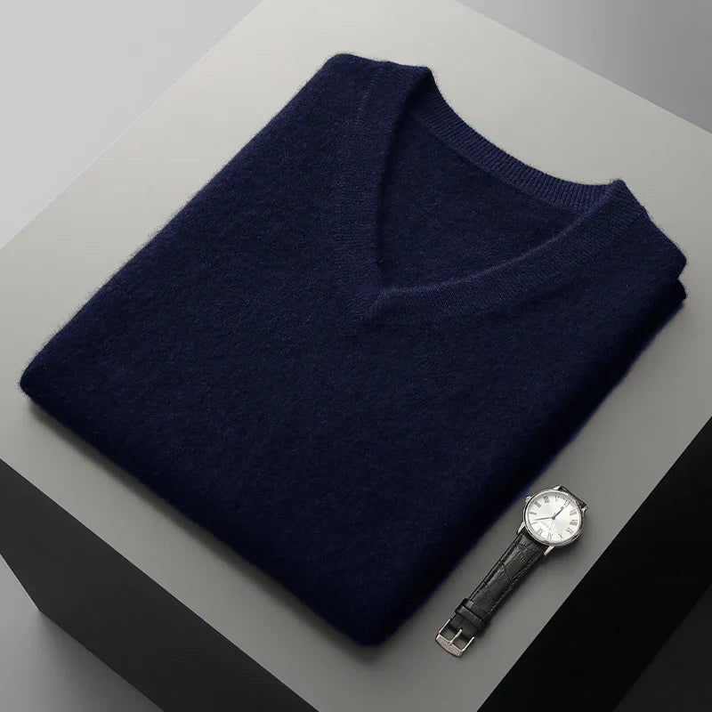 Navy sweater vest folded on a display block showing the ribbed neckline
