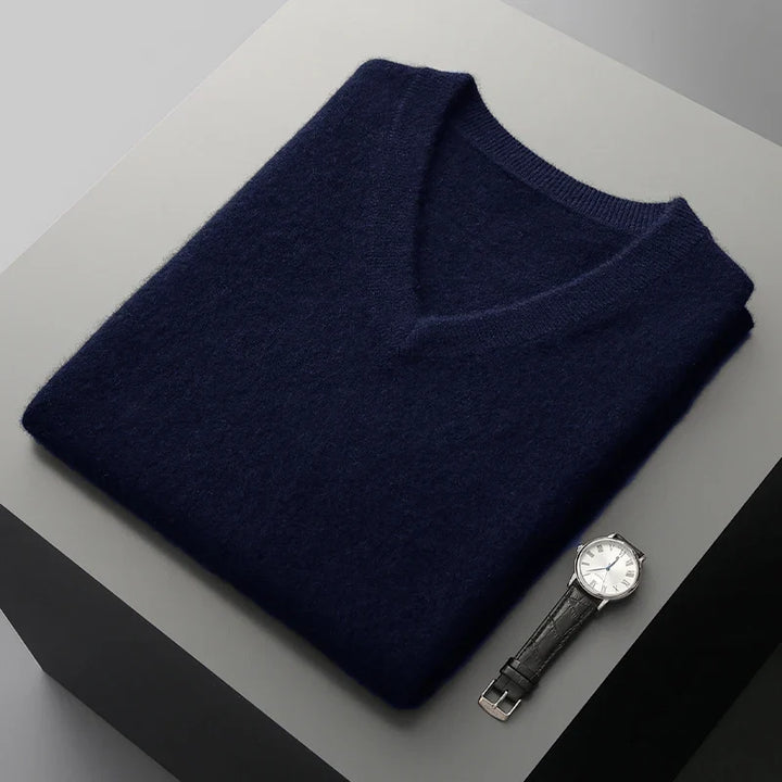Navy sweater vest folded on a display block showing the ribbed neckline