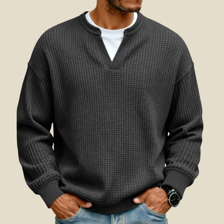 Black waffle pullover with notched V-neck and mock layered collar