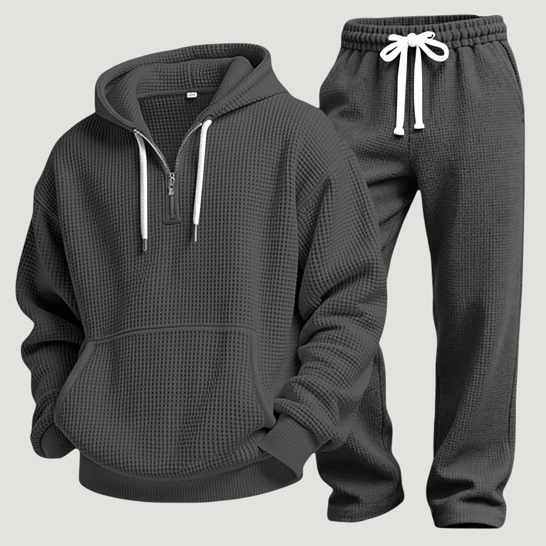 Black waffle knit hoodie and drawstring joggers laid side by side