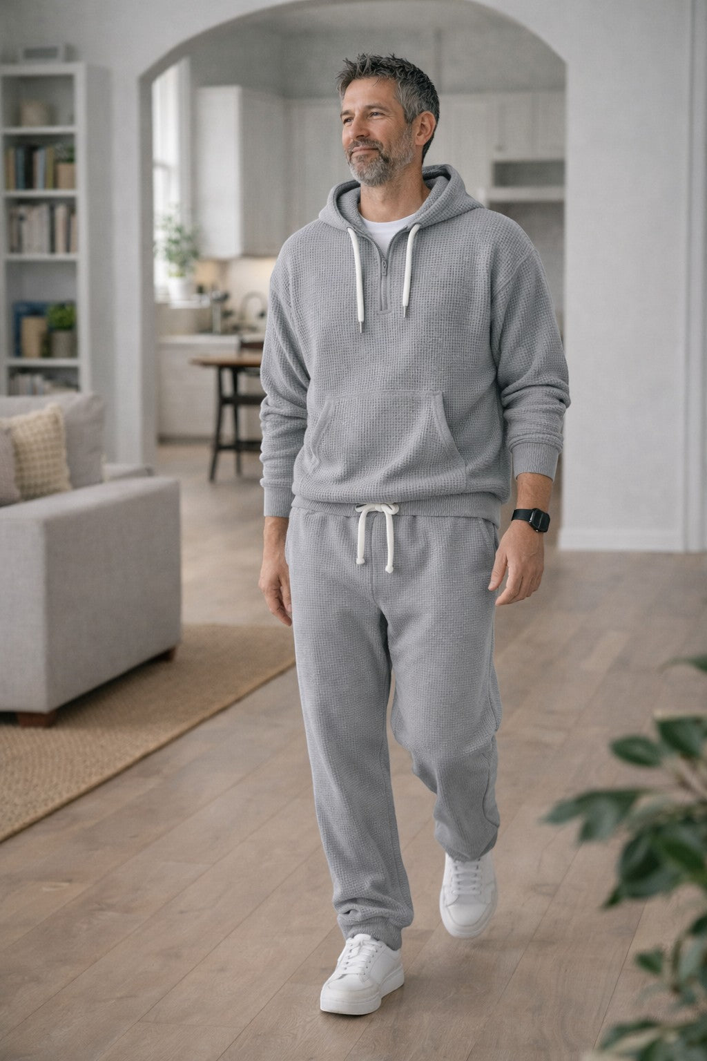 Man walking indoors in the gray waffle hoodie and matching joggers