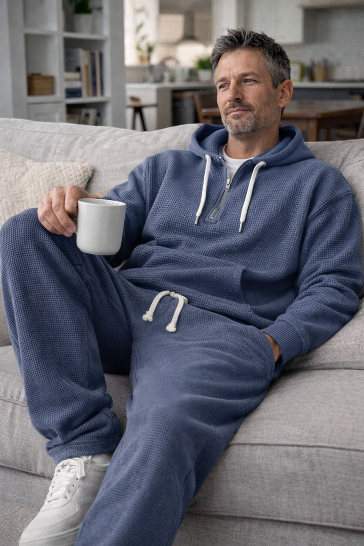 Navy waffle set worn relaxed on a sofa, showing the drawstring waist