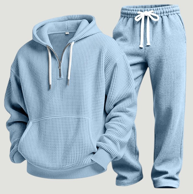 Sky blue half zip hoodie with kangaroo pocket next to matching joggers