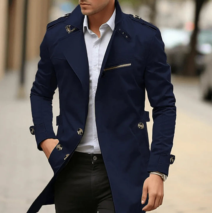 Navy trench coat with epaulettes, model walking with a hand in pocket