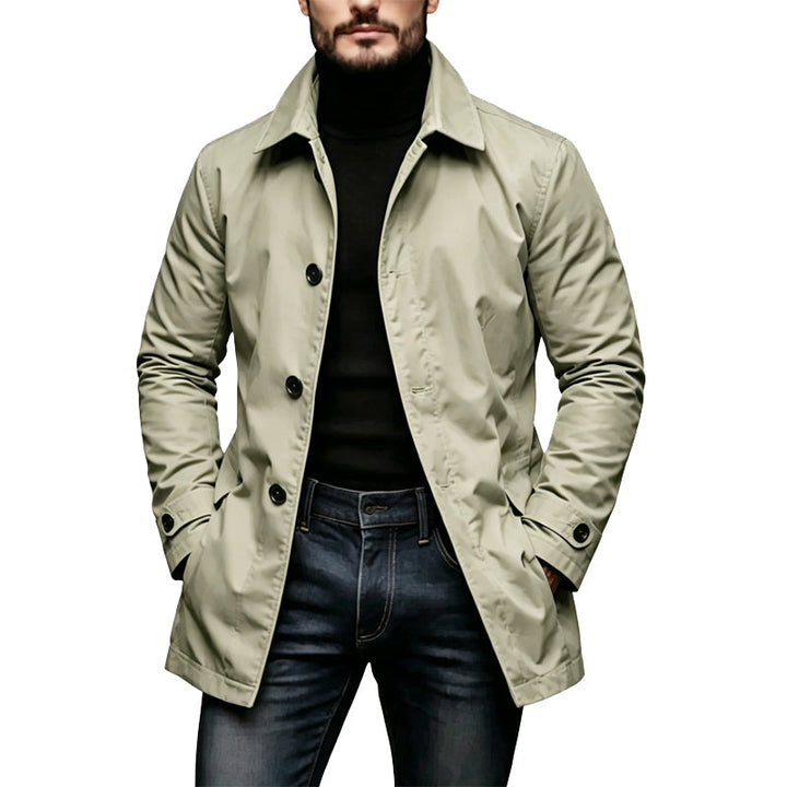 Khaki car coat with collar styled over a black turtleneck and dark jeans