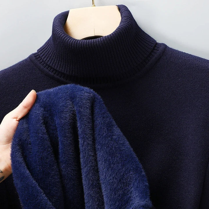 Navy turtleneck pullover on a hanger with the fleece lining visible at the sleeve