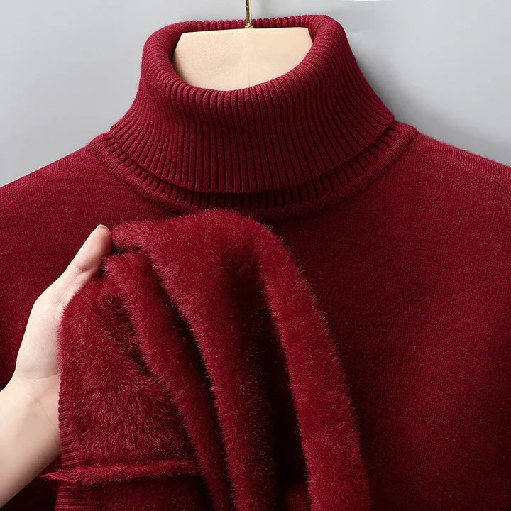 Red turtleneck pullover on a hanger with the fleece lining visible at the sleeve