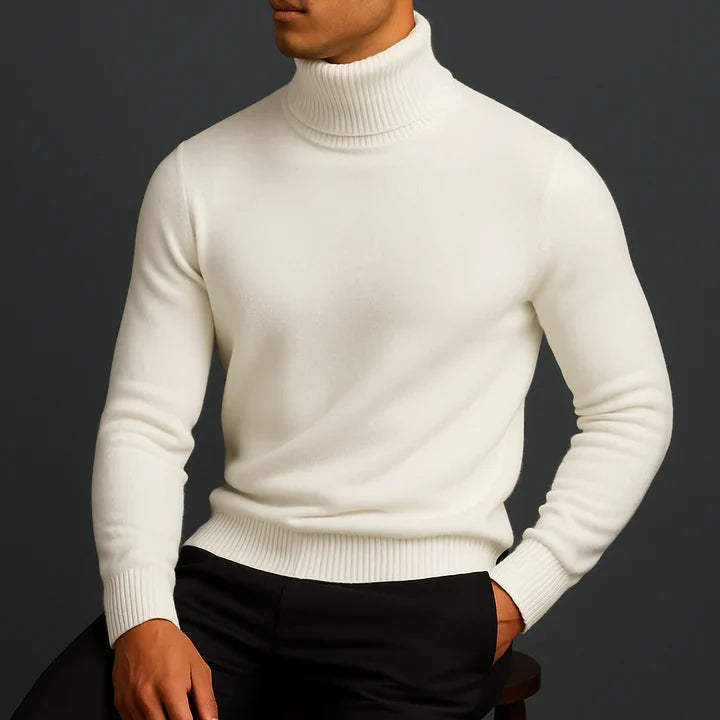 Man wearing a white turtleneck pullover with hands in pockets