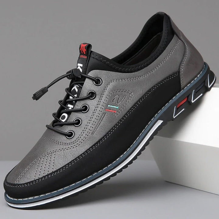 Gray two tone elastic lace walking shoe with black sole, side view