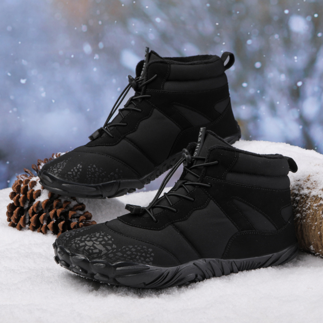 Pair of black quick lace boots resting on snow beside pine cones