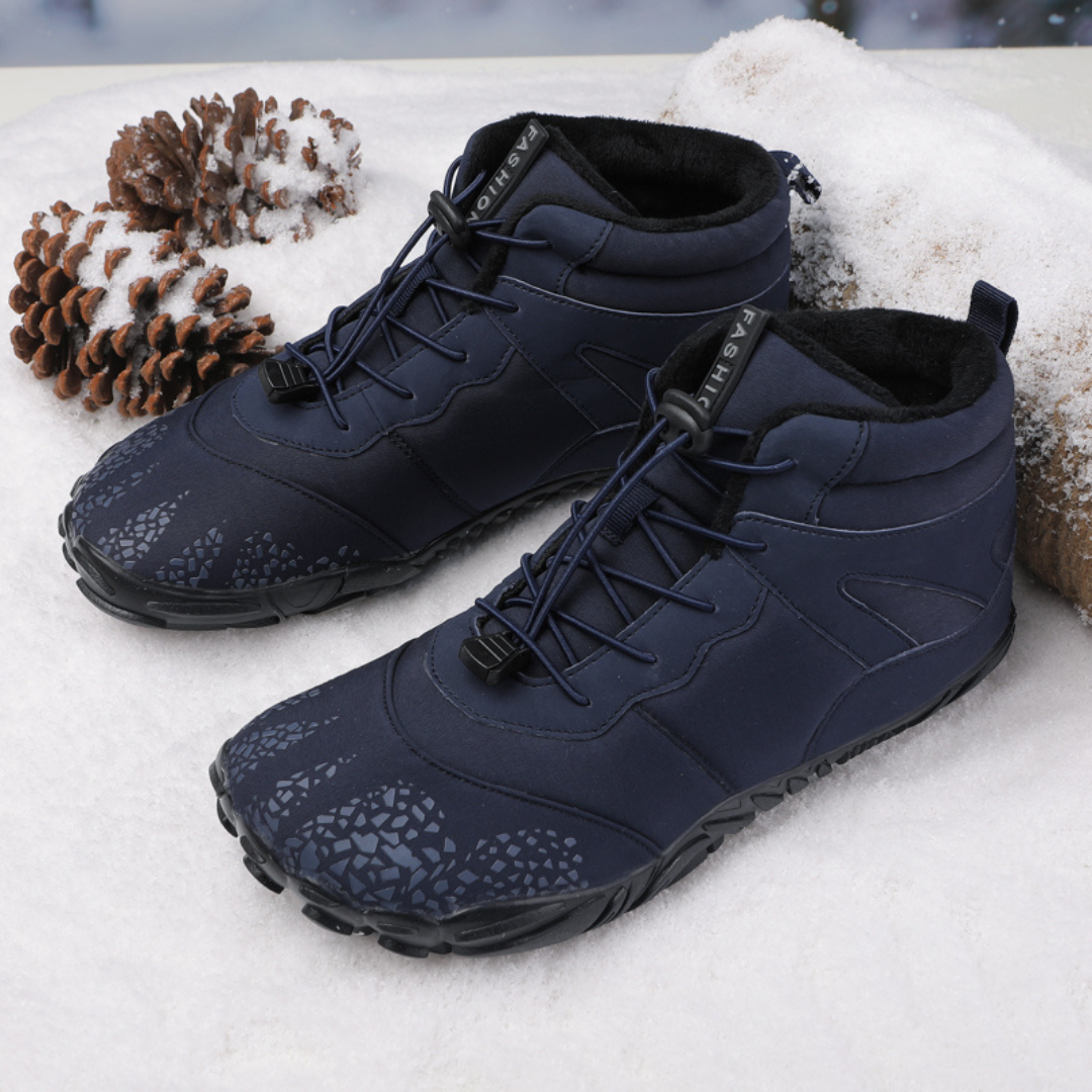 Pair of navy quick lace boots on snow with pine cones