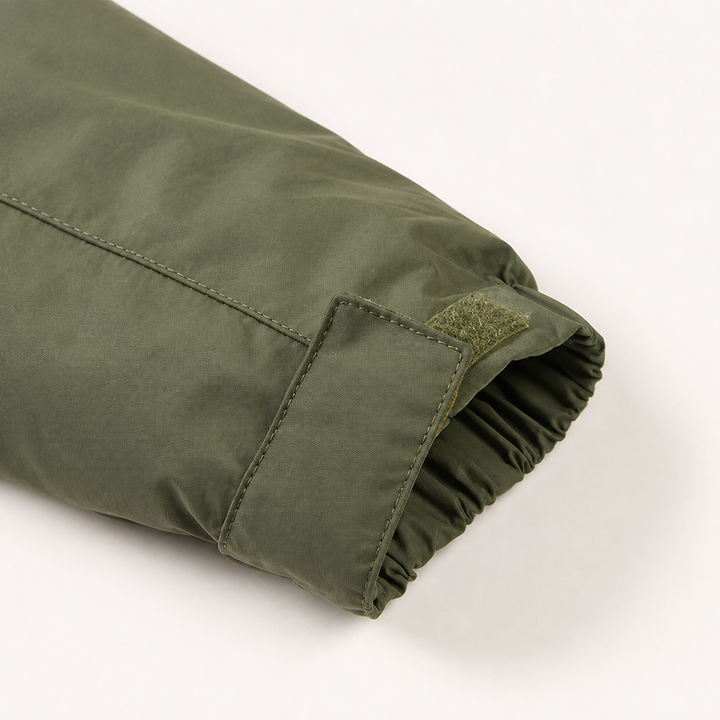 Close-up of the olive windbreaker sleeve cuff with hook-and-loop strap