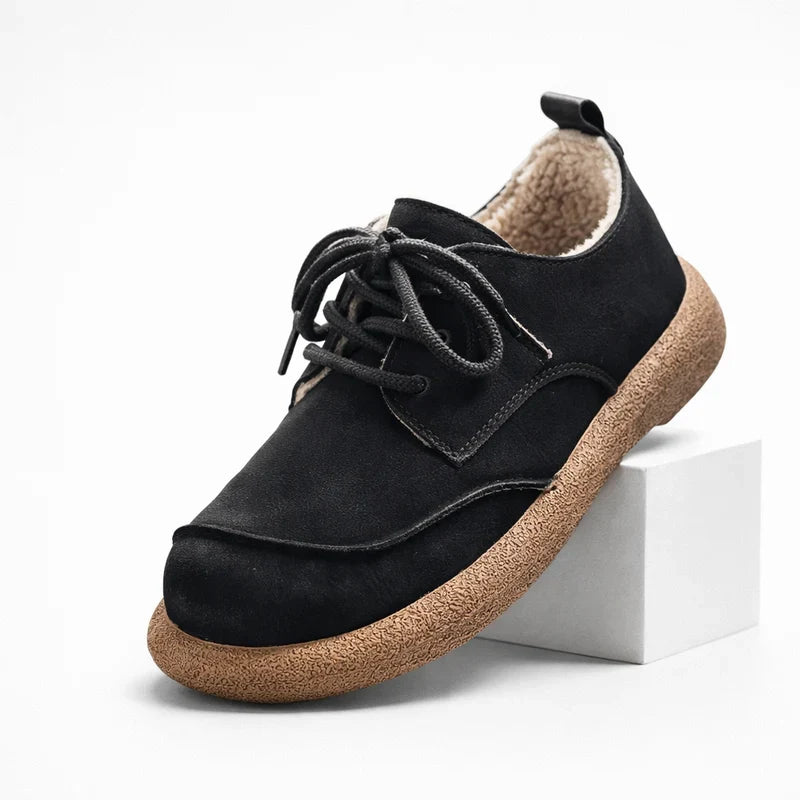 Black fleece lined lace up shoe with crepe sole, angled side view