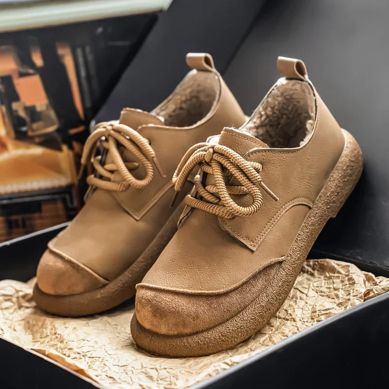 Pair of tan fleece lined lace up shoes on a display box