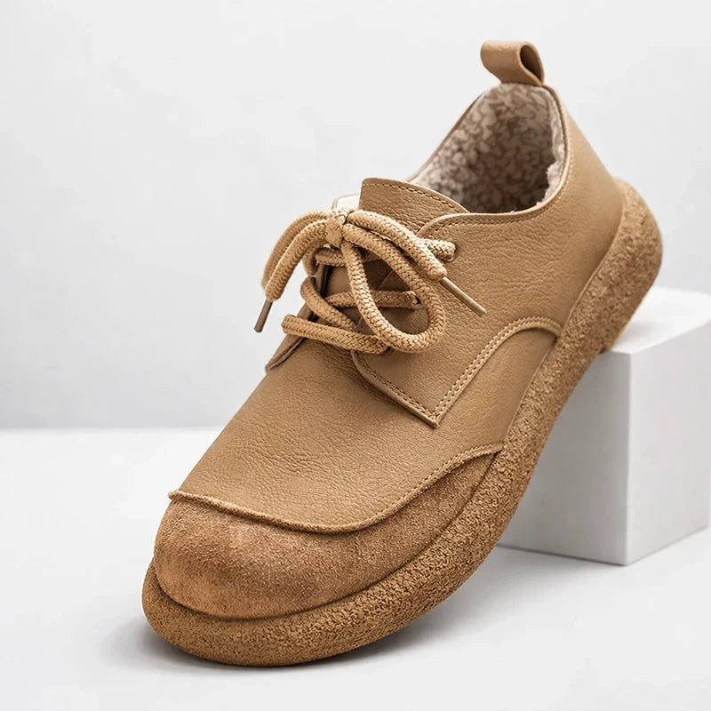 Tan fleece lined lace up shoe with crepe sole, angled side view