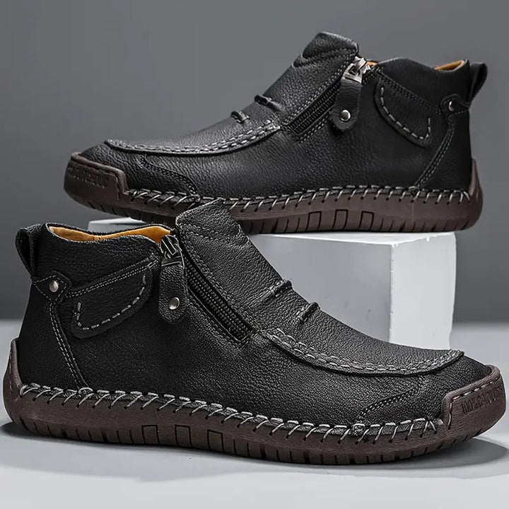 Pair of black side zip ankle boots with stitched toe and dark sole