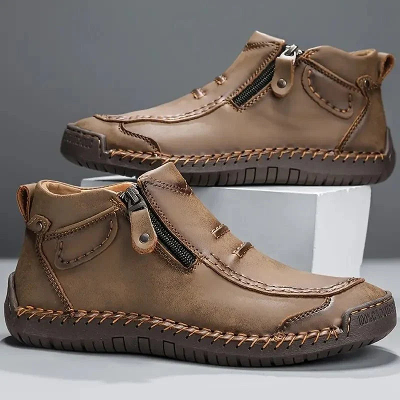 Pair of khaki side zip ankle boots with stitched toe and dark sole