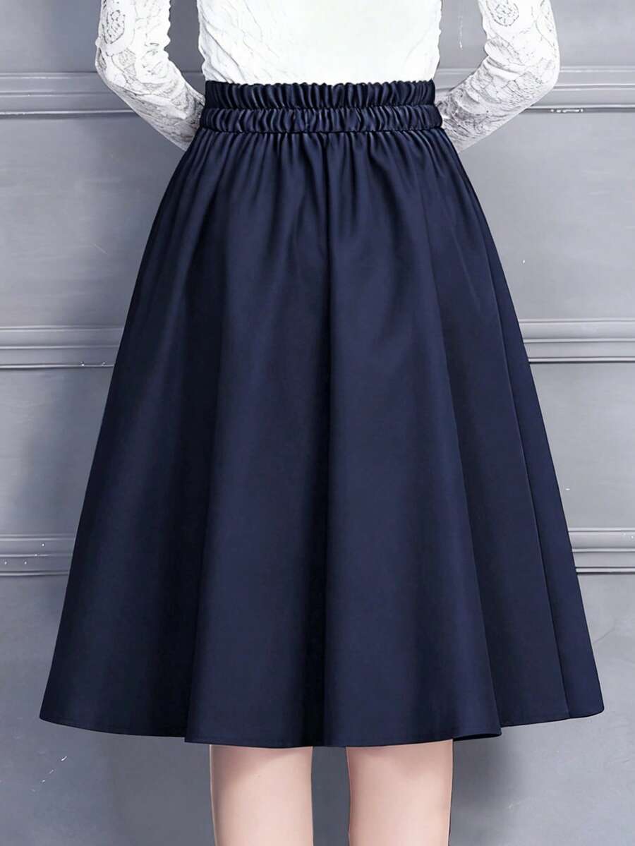 Back of the navy a line midi skirt showing the elastic waistband