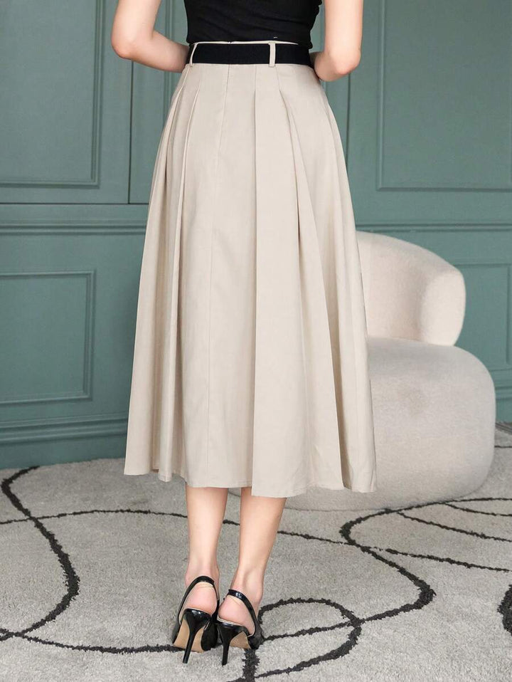 Beige pleated midi skirt with black belt at the waist, front view