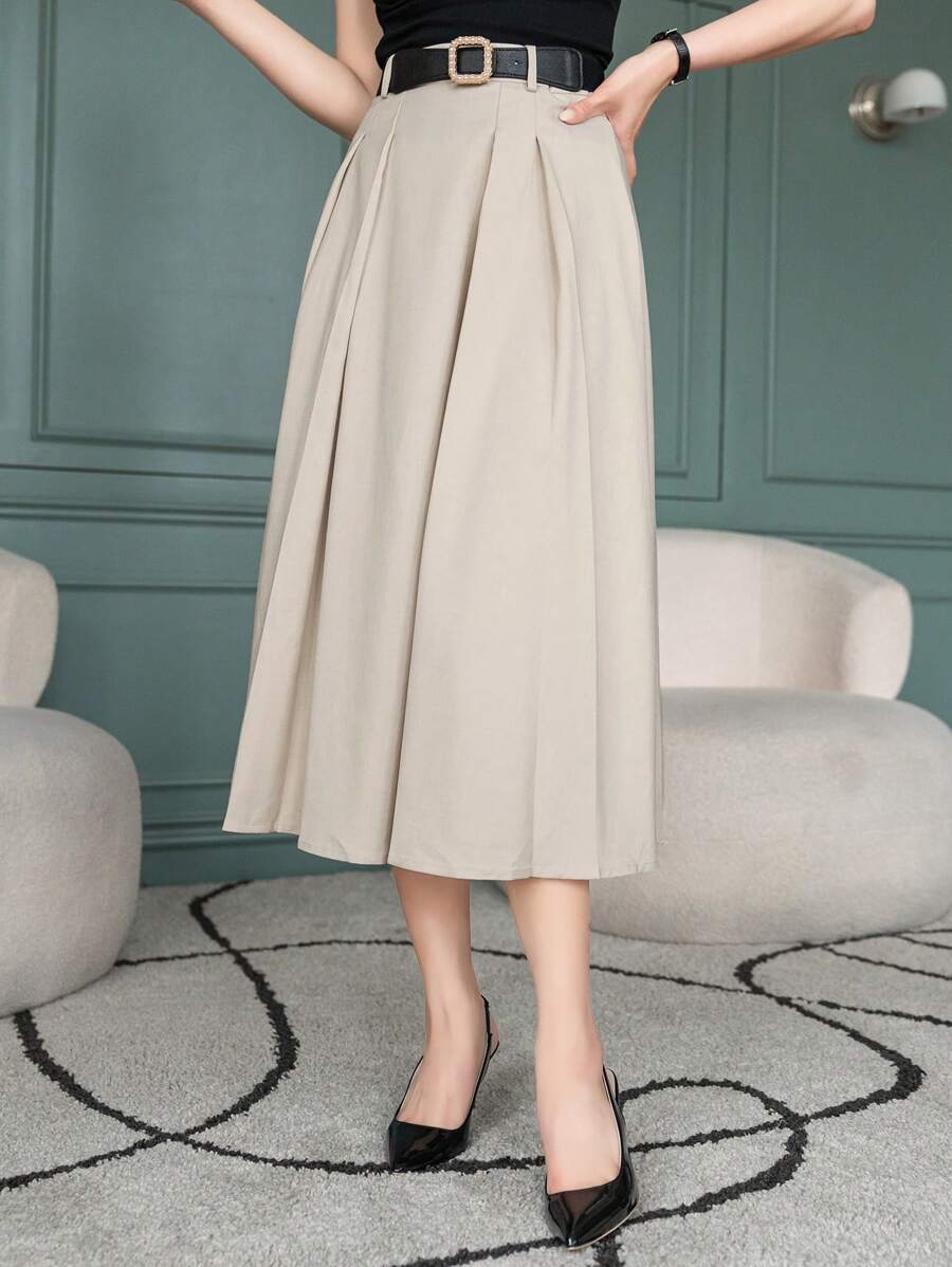 Beige A line skirt with box pleats, three quarter view with black belt