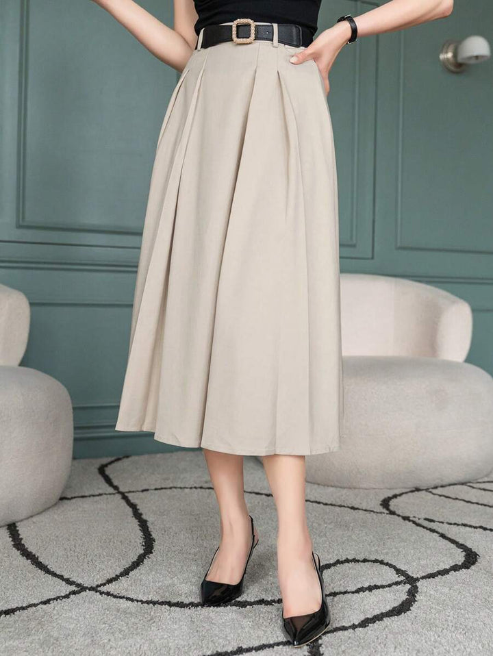 Beige A line skirt with box pleats, three quarter view with black belt