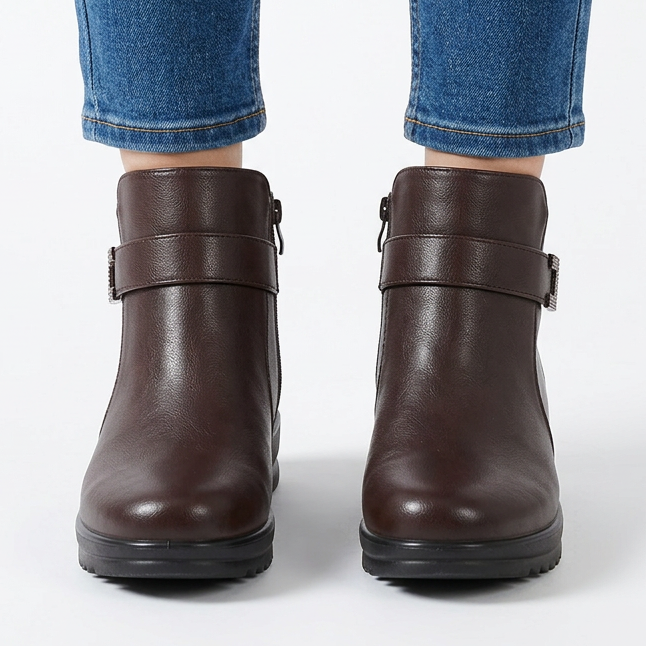 Front view of dark brown wedge ankle boots with buckle strap