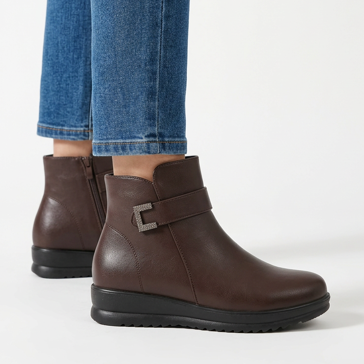 Side view of the dark brown wedge ankle boot with buckle strap and ridged sole
