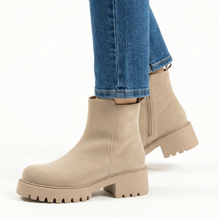 Side view of beige chunky suede-look booties with lug sole