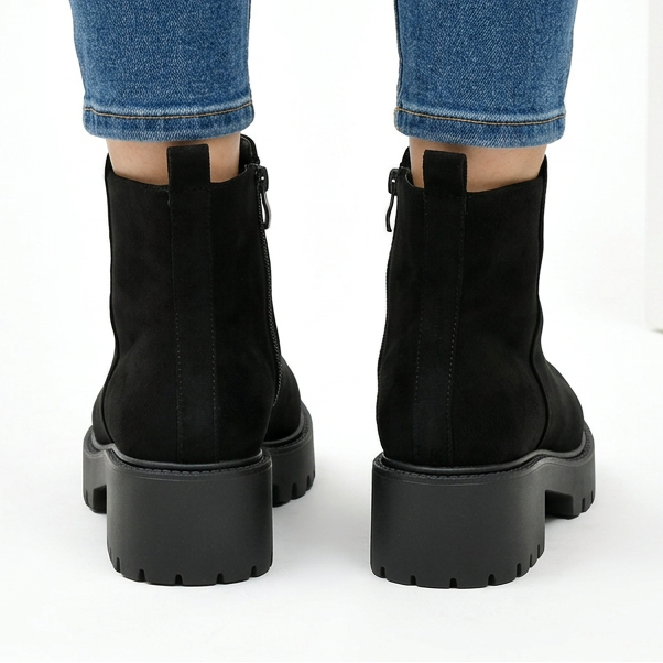 Back view of black chunky suede-look ankle boots with pull tab