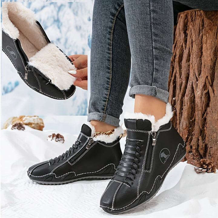 Black fur lined ankle boots with white stitching