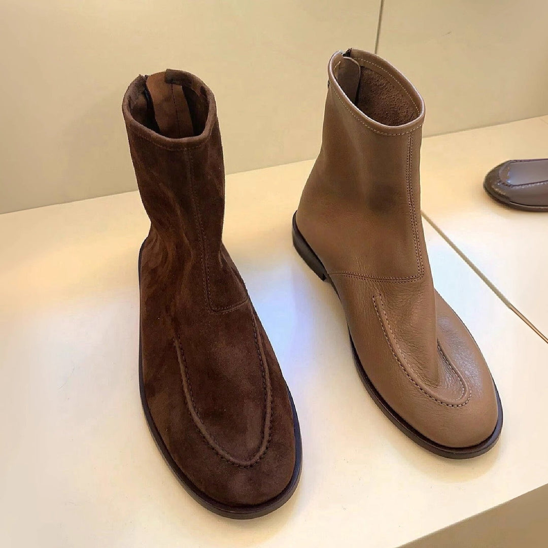 Side view of brown flat ankle boots with round toe