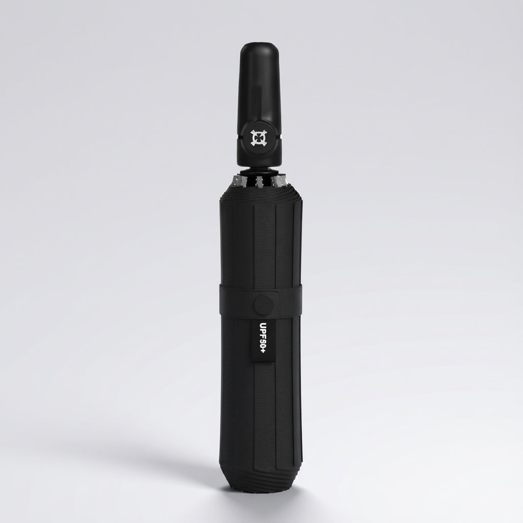 Automatic folding umbrella in all black, closed and standing upright