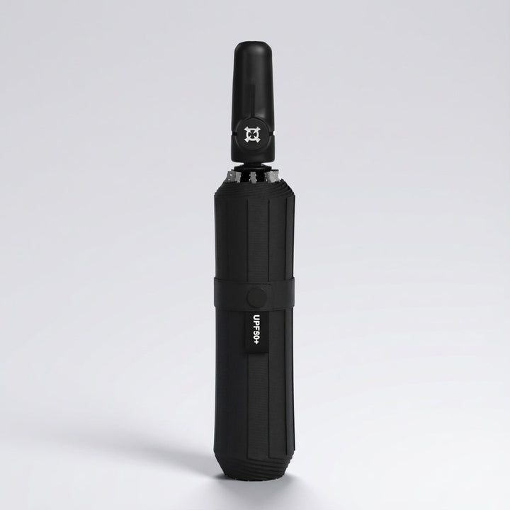 Automatic folding umbrella in all black, closed and standing upright