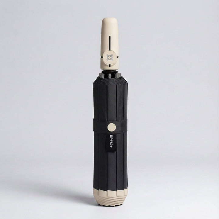 Automatic folding umbrella in beige accent, closed and standing upright
