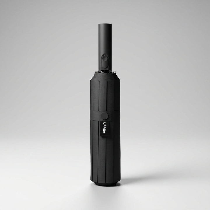 Automatic folding umbrella in black, closed and standing upright