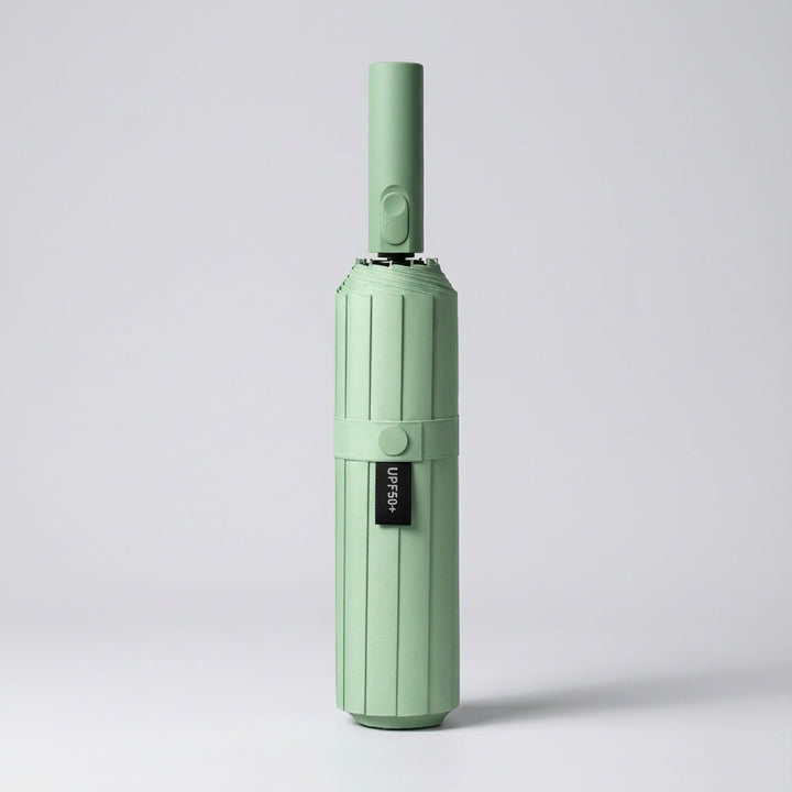Automatic folding umbrella in mint, closed and standing upright