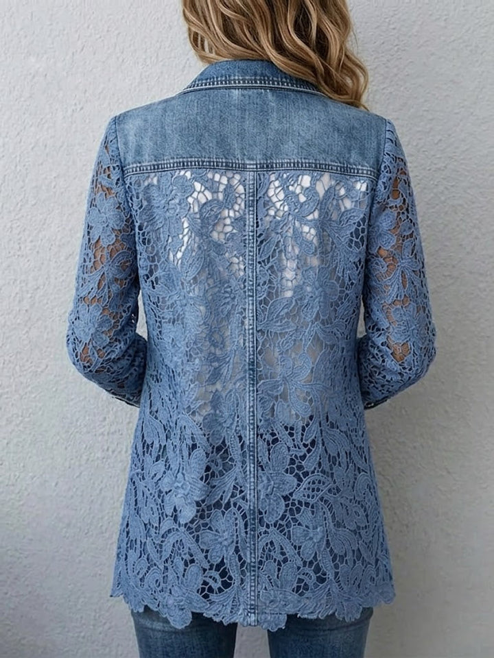 Back of the blue lace blazer showing the open floral pattern and scalloped hem