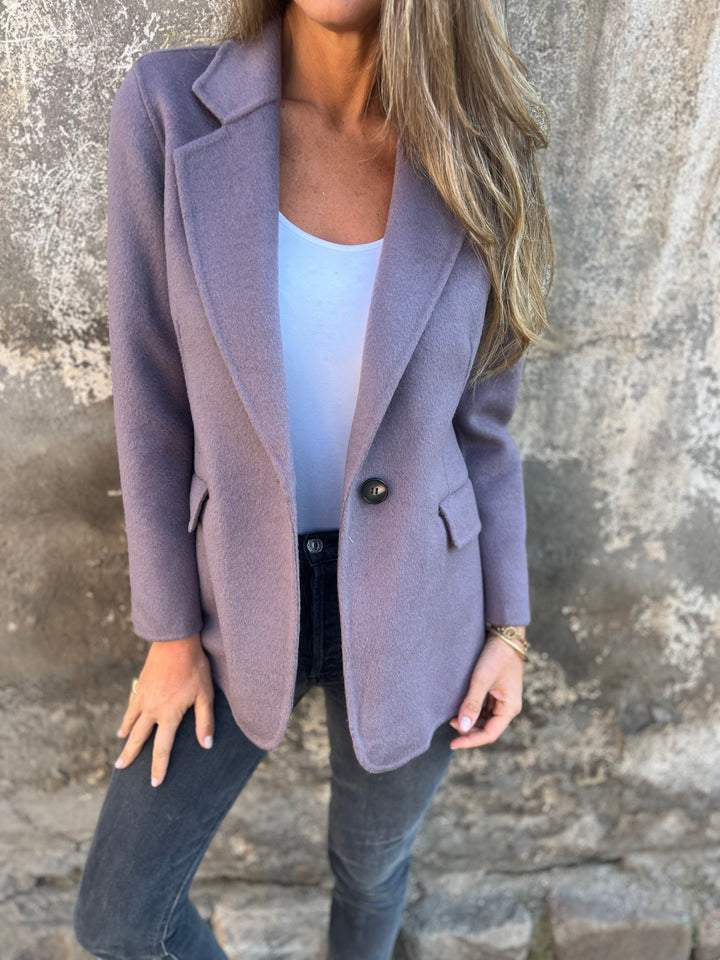 Lavender tailored blazer with notch lapels and dark skinny pants