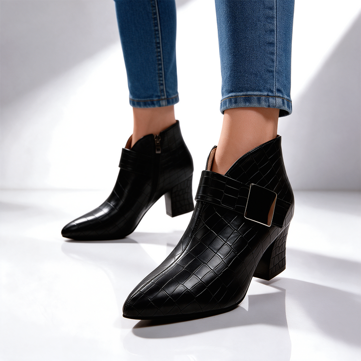 Black block heel ankle boots worn with cuffed jeans, side angle
