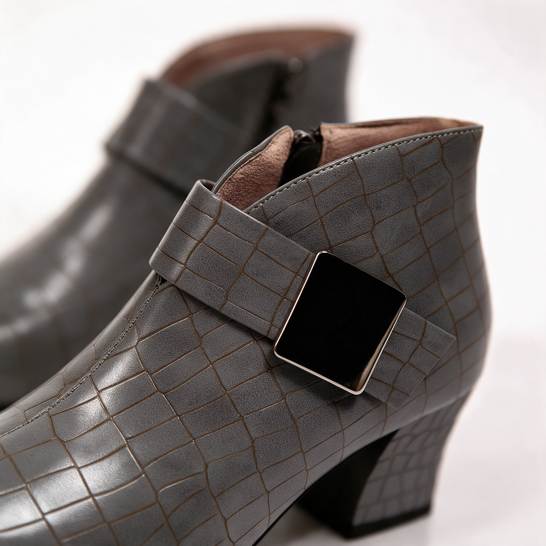 Close-up of the taupe croc embossed upper and square buckle detail