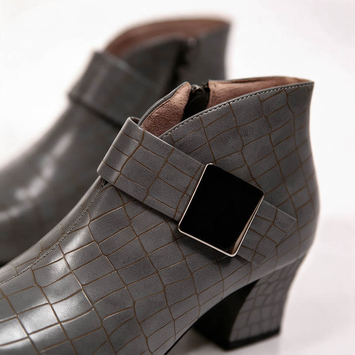 Close-up of the taupe croc embossed upper and square buckle detail